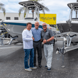 John Duggan and Representatives from Crownline posing in front of a Crownline Finseeker Boat for Sale at Black Label Marine Group