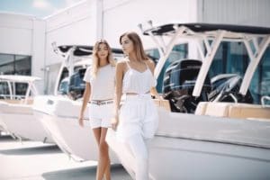 two-woman-at-dealership-shopping-for-caymas-boats-for-sale-white-clothes