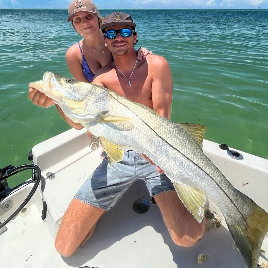 couple holding a snook