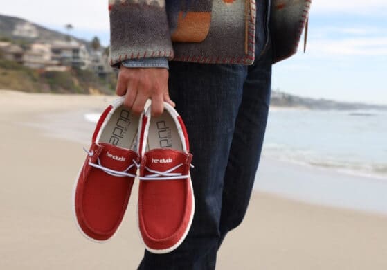 hey-dude_red-shoes-carried-on-beach