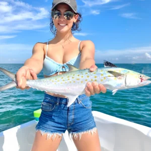 woman holding Spanish mackerel