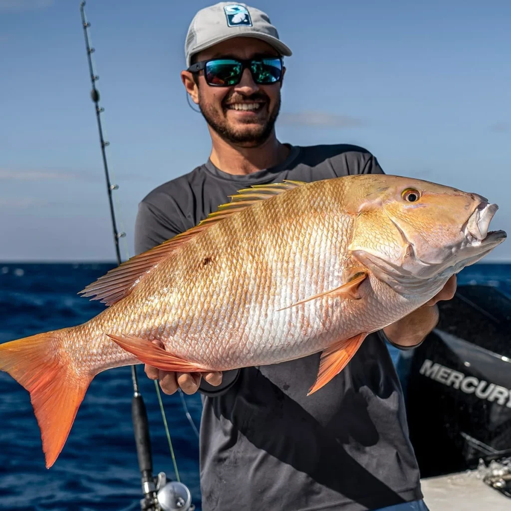 guy holding mutton snapper