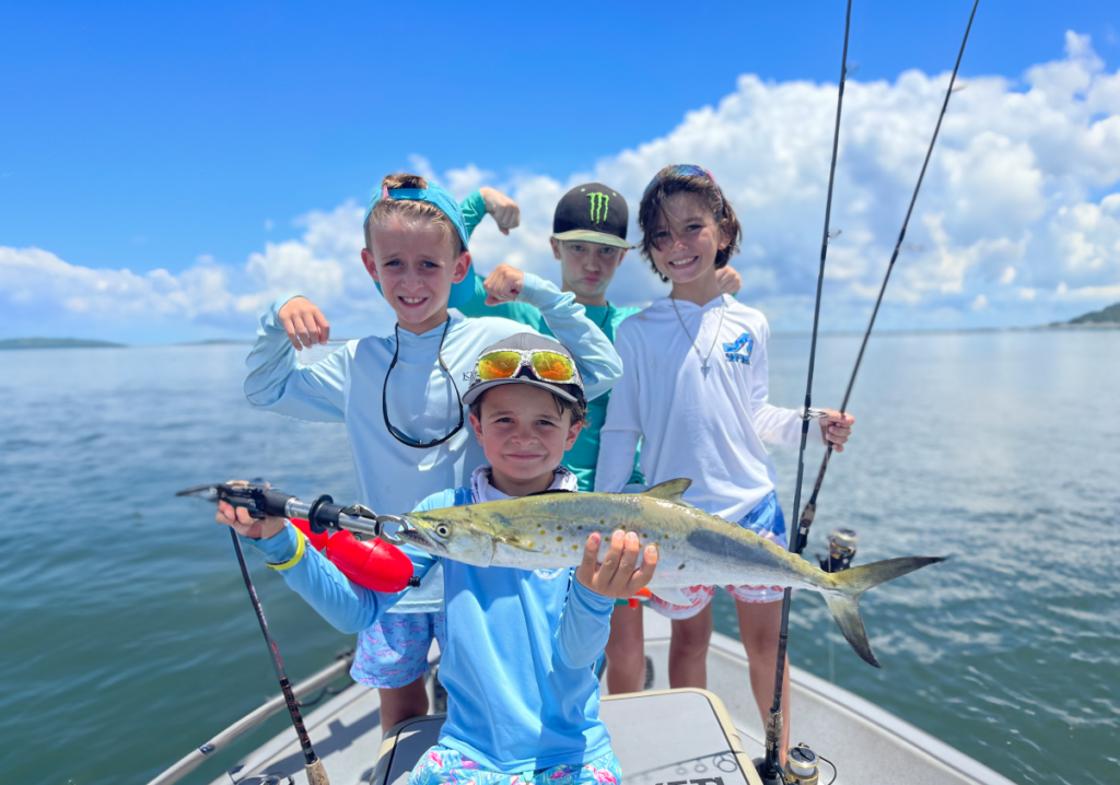 Kids fishing on a boat